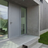 Entrance of a modern house in concrete and wood, outside